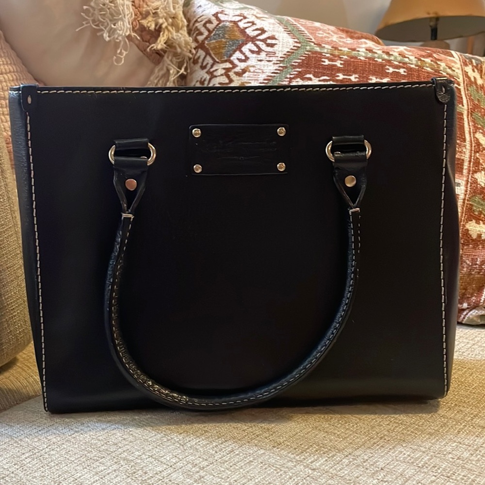 kate spade black handbag with pink and gold polka dot interior
